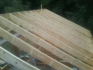 New roof rafters set over an addition before sheathing in Bellingham